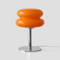 Lampe en verre orange à abat-jour arrondi à deux niveaux et pied chromé, vue de face